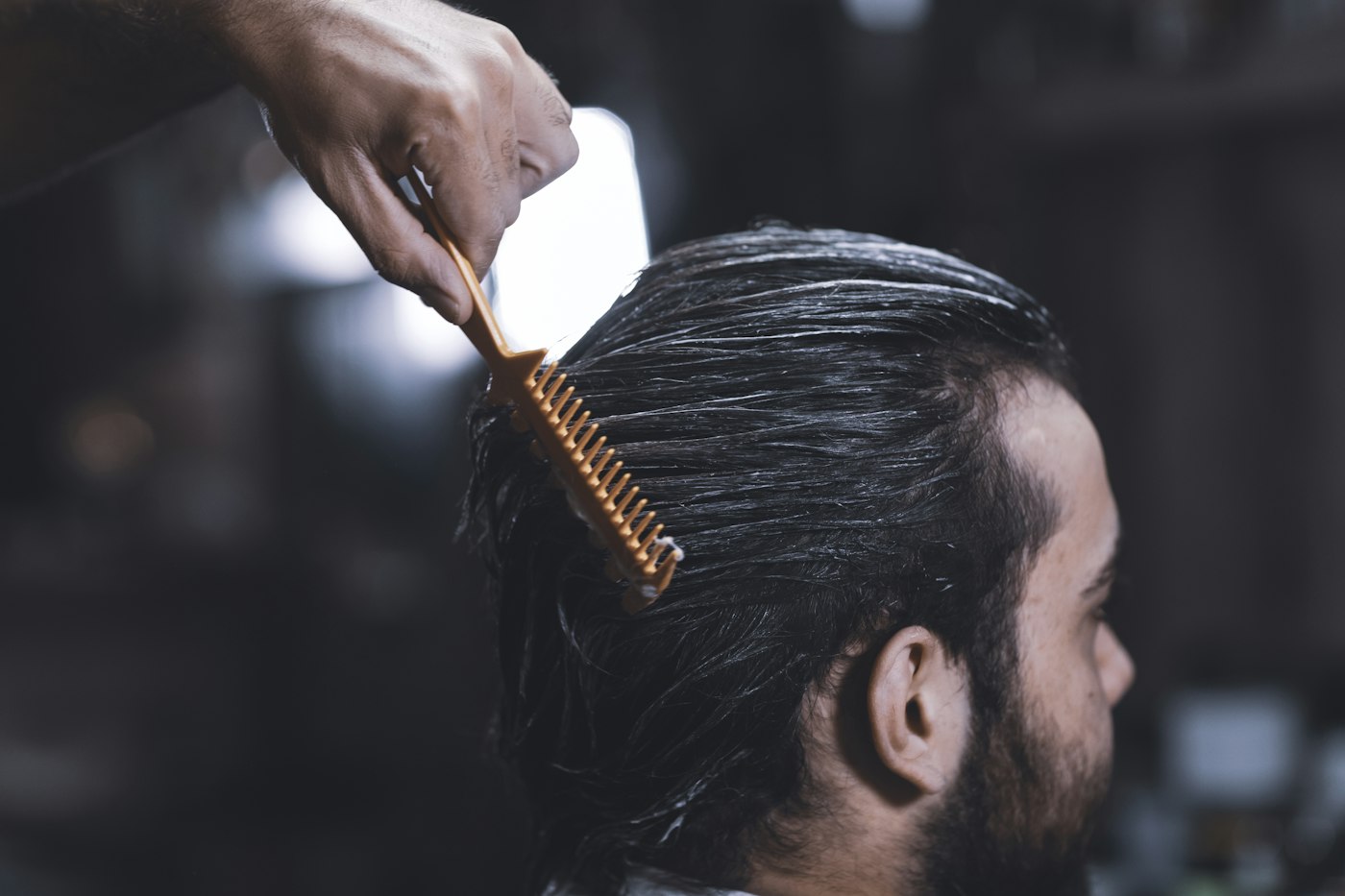 Illustrative example of a man’s side-parted hair being combed; not a Fade Check customer